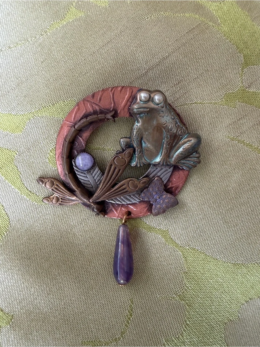 Brooch with whimsical frog and dragonfly on wreath in mixed metals. See photos